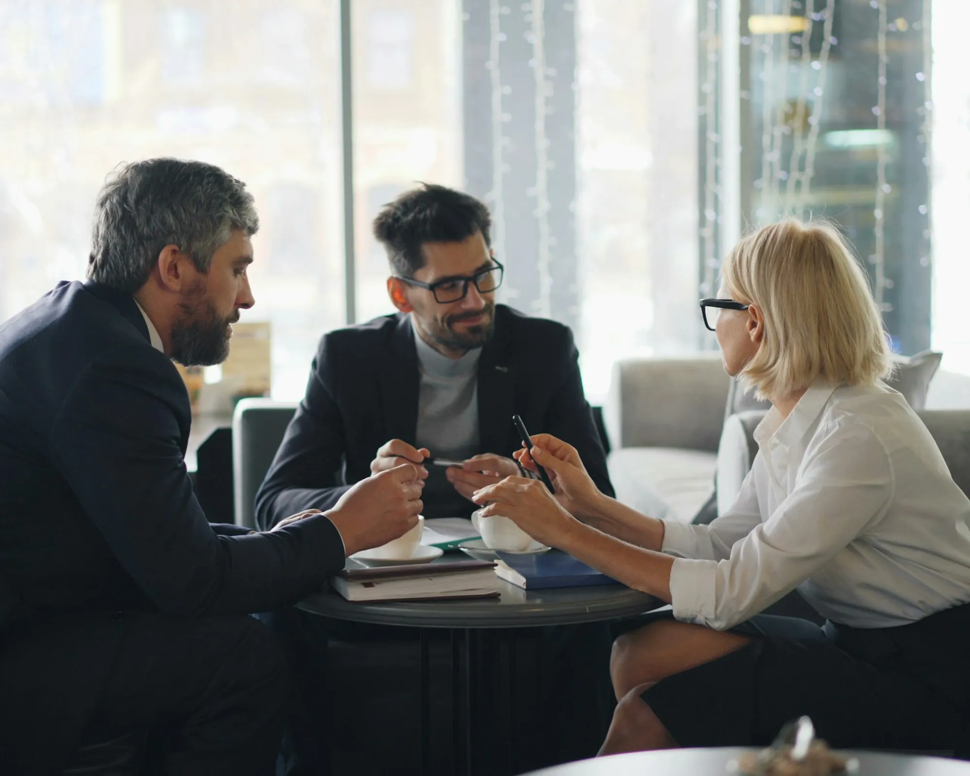 Healthcare professionals reviewing payer contract terms at a conference table